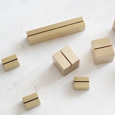 several pieces of wood sitting on top of a white surface