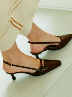 ARER is a brand that reinterprets a linear city, the flow of nature that flexibly blends within it, and traditional and modern culture with our own unique touch.- Sophisticated handmade shoes- Slim and soft line last shape- Attractive buckle strap point- Soft and lightweight to wear Brown Slingback Pumps With Wrapped Heel, Elegant Brown Low Heel Slingback Sandals, Elegant Brown Slingback Pumps For Spring, Chic Brown Slingback Pumps With Sculpted Heel, Elegant Brown Slingback Sandals With Sculpted Heel, Designer Slingback Heels With Buckle Closure, Elegant Brown Slingback Sandals With Buckle Closure, Elegant T-strap Slingback Sandals With Removable Insole, Leather T-strap Slingback Sandals With Buckle