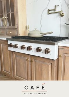 a white stove top oven sitting inside of a kitchen next to wooden cupboards and cabinets