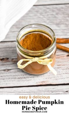 homemade pumpkin pie spice in a glass jar with cinnamon sticks on the side and text overlay that reads easy & delicious homemade pumpkin pie spice