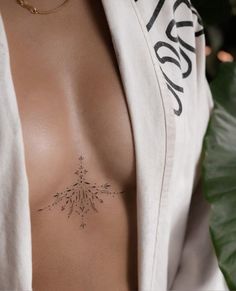 a woman's chest with a tattoo on it