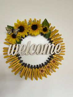 a sunflower wreath with the word welcome on it