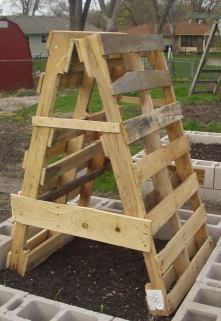 a wooden ladder sitting on top of cement blocks