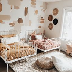 a bedroom with two beds and pillows on the floor