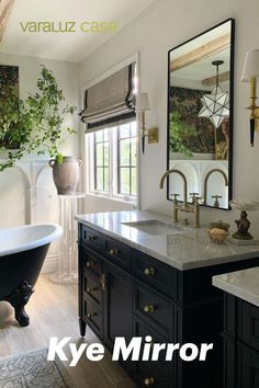 a bath room with a tub a sink and a mirror