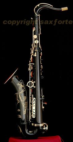 a black and gold saxophone sitting on top of a table