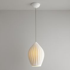 a white light hanging from the ceiling in a room with gray walls and flooring