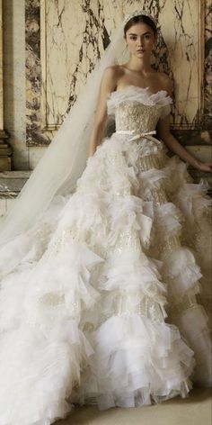 a woman in a wedding dress with a veil on her head