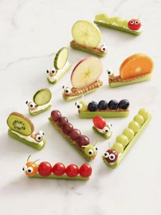 various fruits and veggies are arranged in the shape of caterpillars