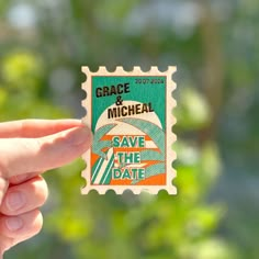 a hand holding up a stamp with the words grace and michael save the date on it