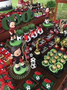 a table filled with lots of cupcakes and cake decor on top of it