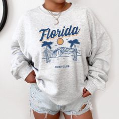 Florida Sweatshirt Preppy Sweatshirt Clearwater Crewneck Beach Sweatshirt Trendy Crewneck Aesthetic Crewneck Moving To Florida Hoodies Ideal for any situation, a unisex heavy blend crewneck sweatshirt is pure comfort. These garments are made from polyester and cotton. This combination helps designs come out looking fresh and beautiful. The collar is ribbed knit, so it retains its shape even after washing. There are no itchy side seams on these sweaters. .: 50% Cotton 50% Polyester .: Medium-heav Florida Hoodie, Hawaii Crewneck, Florida Sweatshirt, Crewneck Aesthetic, Hawaii Sweatshirt, Sweatshirt Preppy, Aesthetic Crewneck, Preppy Sweatshirts, California Sweatshirt