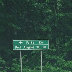 a street sign in front of some trees