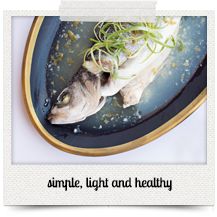 a fish on a plate with some sprouts in it's mouth that says, simple light and healthy