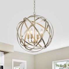 a chandelier hanging from the ceiling in a room with white walls and windows