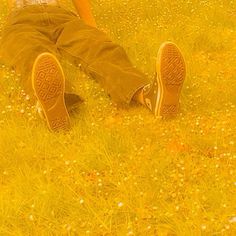 a person laying in the grass with their feet up