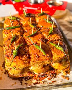 some food is sitting on a tray with toothpicks sticking out of the meat