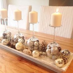 a wooden table topped with candles and ornaments