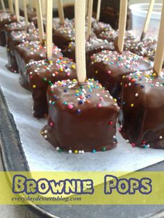 brownie pops with chocolate and sprinkles are on a baking sheet, ready to be eaten