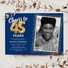 a blue and gold birthday card with a photo of a woman in the middle, surrounded by leaves