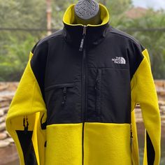 Color: Lemon Relaxed Fit Tumbled Classic Fleece Dwr Finish Helps Keep You Dry Center Front Zip Puller Has The Original Logo Covered, Secure-Zip Chest Pockets Has The Silhouette Of The 1995 Original Stretch-Binding Finish At Cuffs Zip-In-Compatible Integration With The Mountain Jacket And The Mountain Light Jacket Exposed-Tape Hand Pockets Exposed, Vislon Center Front Zip Center Back: 27" Body: 100d 360 G/M 100% Recycled Polyester Knit With Durable Water-Repellent (Dwr) Finish The North Face Fleece Jacket With Pockets For Streetwear, The North Face Hooded Fleece Jacket For Streetwear, The North Face Long Sleeve Fleece Jacket For Streetwear, The North Face Sporty Long Sleeve Outerwear, Fitted Winter Track Jacket For Streetwear, Sporty Long Sleeve Outerwear By The North Face, Fitted Track Jacket For Winter Streetwear, Fitted Track Jacket With Pockets For Streetwear, Sporty Long Sleeve North Face Fleece Jacket