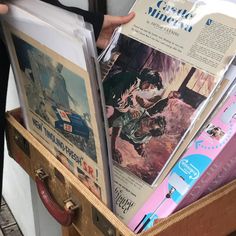 an open suitcase filled with books and magazines