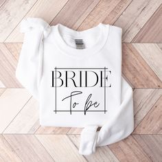 the bride to be sweatshirt is shown on top of a wood floor with a white background