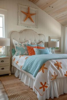 a bed in a bedroom with white walls and wooden ceilings, along with starfish pillows