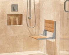 a shower with a wooden seat next to a wall mounted shower faucet and soap dispenser