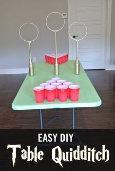 an easy diy table quidditch with cups on it and candles in the middle