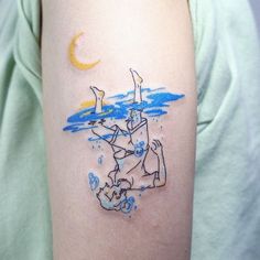 a woman with a tattoo on her arm has a drawing of a man and dog in the water