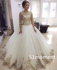 a woman standing in a room wearing a wedding dress with gold sequins on it