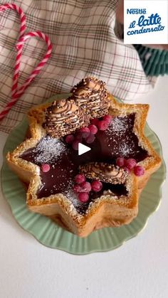 a star shaped pastry on a green plate with candy canes in the shape of a christmas tree