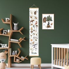 a baby's room with green walls and wooden furniture, including a crib