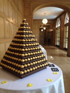 a large chocolate cake with gold decorations on it's top and bottom tiers