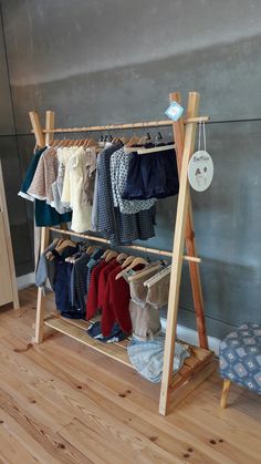 a wooden rack with clothes hanging on it