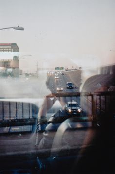 a blurry photo of cars driving down the road