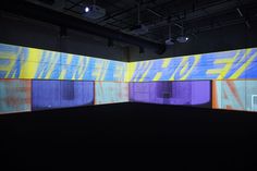 an empty room with multiple colored panels on the wall