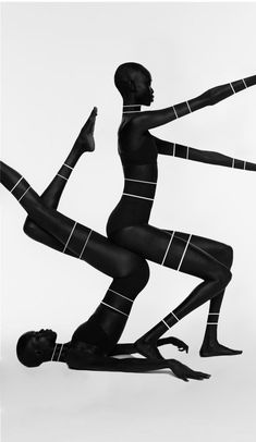 two women in black bodysuits are performing acrobatic tricks on one leg