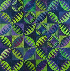 a quilt made with green and purple circles