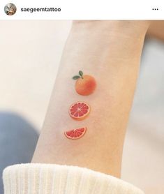 an orange and grapefruit tattoo on the wrist