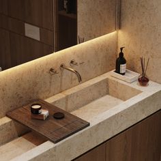 a bathroom sink sitting under a mirror next to a wooden tray with soap and toothbrushes on it