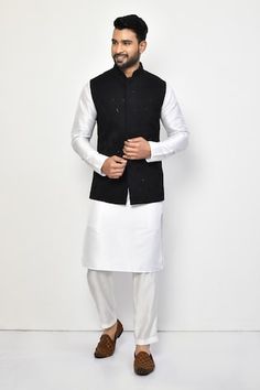 Black sleeveless bundi with sequin, thread embroidery in geometric pattern. Paired with full sleeve kurta and pant. - Aza Fashions Fitted Sleeveless Outerwear For Festive Occasions, Sleeveless Nehru Jacket With Chikankari Embroidery For Festive Occasions, Sleeveless Nehru Jacket With Chikankari For Festive Occasions, Festive Sleeveless Nehru Jacket With Chikankari Embroidery, Fitted Bollywood Style Sleeveless Nehru Jacket, Fitted Sleeveless Bollywood Nehru Jacket, Fitted Sleeveless Nehru Jacket With Zari Work, Designer Sleeveless Fitted Bandhgala, Fitted Sleeveless Nehru Jacket With Resham Embroidery