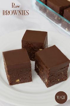 three pieces of brownie on a plate with the words raw brownies written below