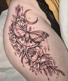 a woman's thigh with a butterfly and flowers on it