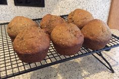 several muffins are cooling on a wire rack