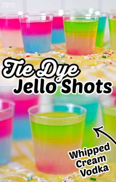 jello shots with whipped cream vodka and sprinkles on the table in front of them