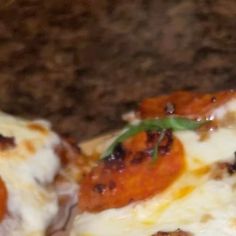 two slices of pizza sitting on top of a counter