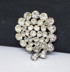 This is a beautiful WEISS brooch with lots of sparkle. Each stone is prong set and there are teardrop and round cut stones. It's a classic 50's/60's WEISS. It is approx. 2 1/4 in. long and 1 3/4 in. wide. It's in good vintage condition. It is signed WEISS. Enjoy!! Albert Weiss worked for the CORO company in the 1930's and learned the trade then in 1942 he opened his own company. The company excelled quickly. They focused on their high standards of quality materials and design. Throughout the 50' Retro Wedding Brooches With Rhinestones, Vintage Sparkling Wedding Brooches, Black Dress Suit, Wedding Brooches, Vintage Rhinestone Brooch, Old Hollywood Glam, Wedding Brooch, Naples Fl, White Rhinestone