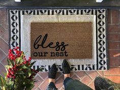 someone is standing in front of a door mat that says,'please our nest '